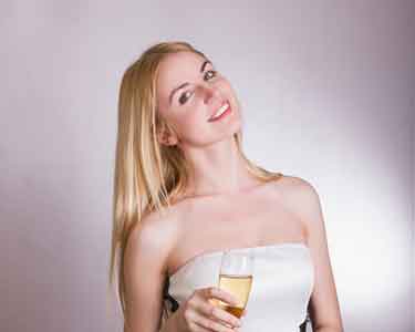 Pretty blond girl with a glass of sparkling wine.